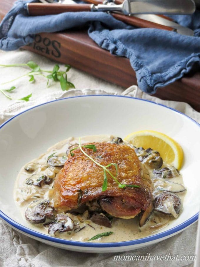 Chicken Thighs with Mushrooms and Tarragon Cream features golden chicken thighs in a white wine and cream sauce flavored with shallots and fresh tarragon. 7 net carbs per serving.