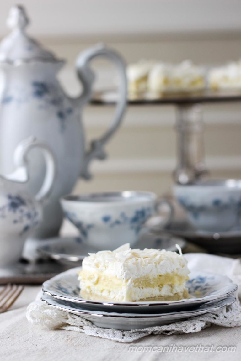 Low Carb Coconut Cream Layered Dessert (Coconut Cream Delight) with shortbread crust, cream cheese, coconut pudding, whipped cream and coconut.