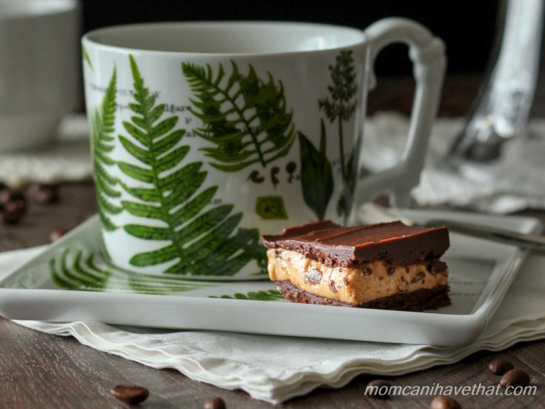 Peanut butter chocolate fat bomb with layers on a plate with a cup