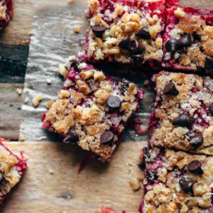 Keto Cranberry Crumb Bars with walnuts and chocolate chips on parchment
