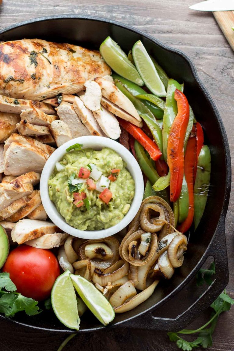 This authentic chicken fajitas recipe results in juicy and flavorful chicken and charred vegetables with minimal effort. Make it easy on yourself and buy the pico de gallo and guacamole from your favorite local taco shop to bring the whole meal together. | Low Carb, Gluten-free, Paleo, Whole 30