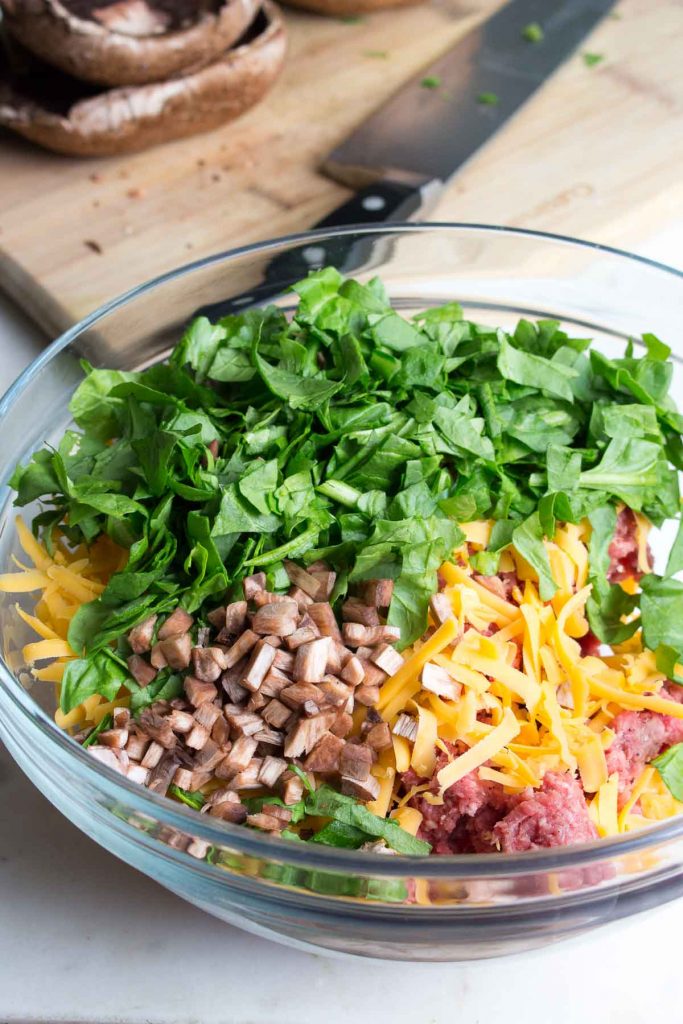 Stuffed portobello burger ingredients in a glass bowl.