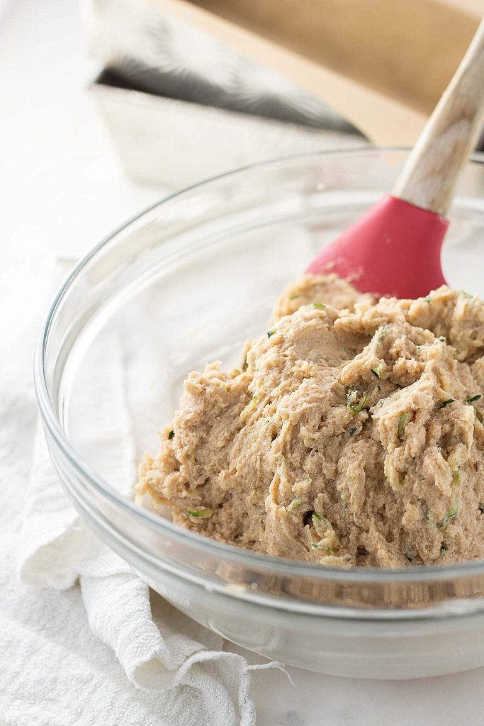 Low Carb Zucchini Bread batter in a clear glass bowl.