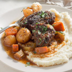 Low carb pot roast with vegetables in gravy served on cauliflower mash. keto, LCHF