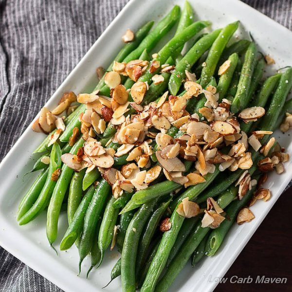 A low carb side of green beans almondine, cooked green beans, melted butter and toasted almonds.