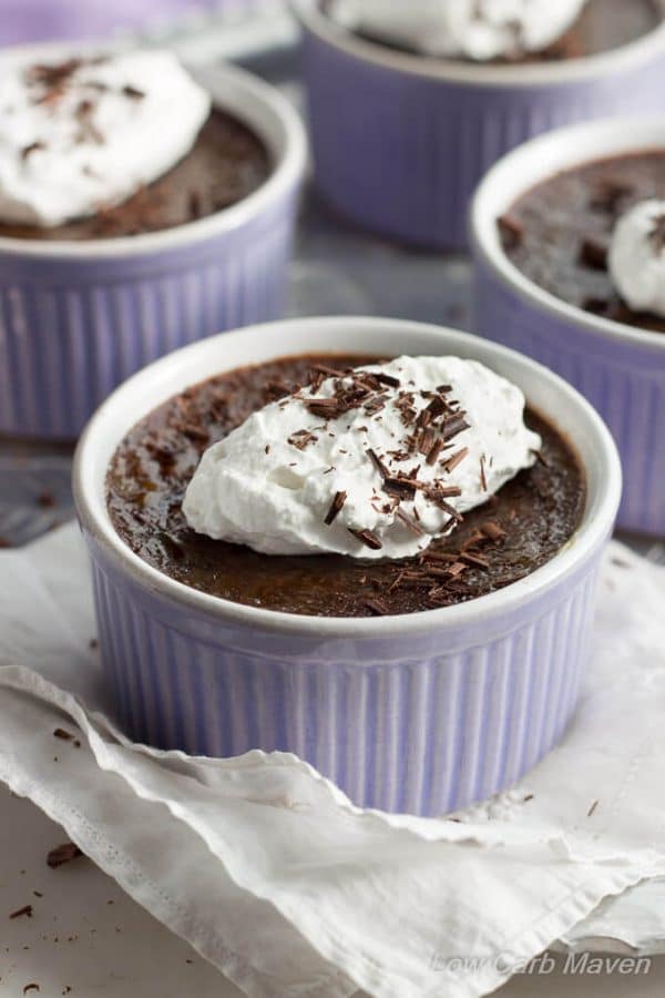 Low Carb Chocolate Truffle Creme Brulee with whipped cream in purple ramekins.