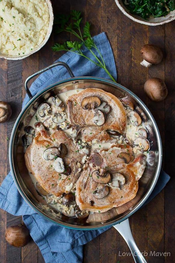 Cream of mushroom pork chops in a pan with sides.