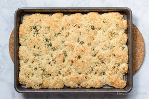 Baked gluten free low carb focaccia with herbs in a pan.