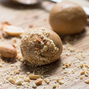 Low Carb Peanut Butter Balls (or peanut butter protein balls) rolled in chopped peanuts.