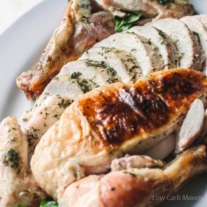 Sliced oven roasted chicken with herbs and herb butter.
