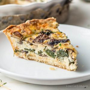 Spinach and mushroom quiche (vegetable quiche) slice on a plate.