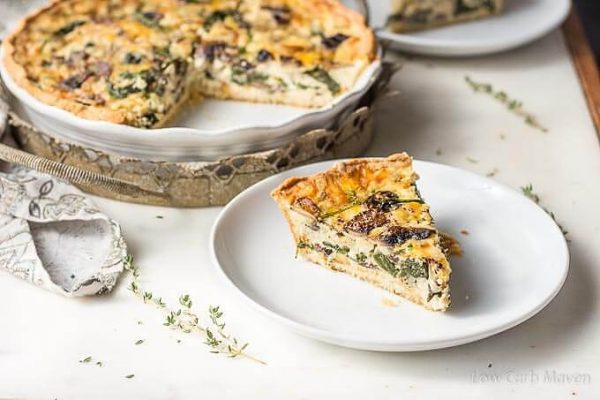 Spinach and mushroom quiche (vegetable quiche) slice on a plate.