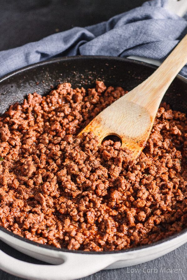 Ground beef for tacos in a pan with bamboo spatula