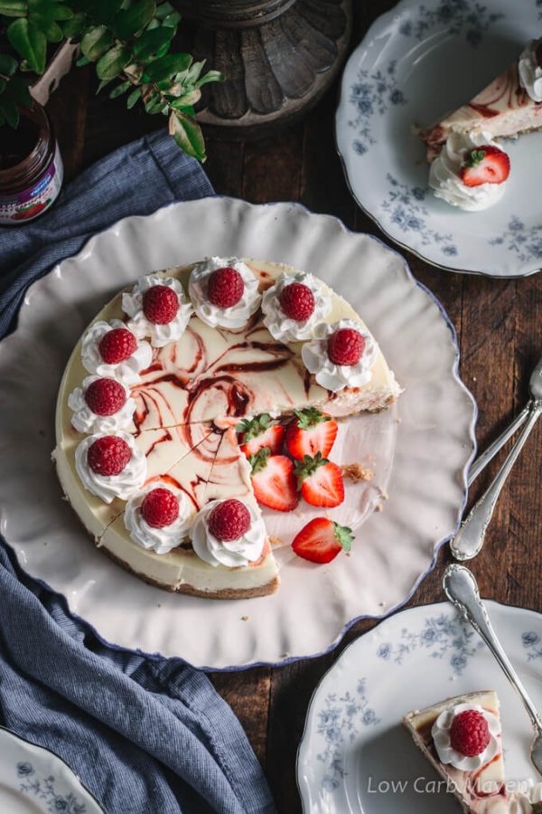 This keto cheesecake with raspberry swirl is delicious and perfect for a low carb and sugar free diet. No-added sugar strawberry/raspberry jam by Sukrin makes the perfect swirl. #ad