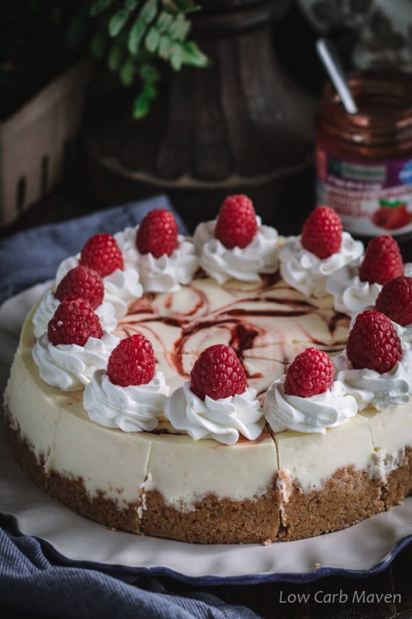 This keto cheesecake with raspberry swirl is delicious and perfect for a low carb and sugar free diet. No-added sugar strawberry/raspberry jam by Sukrin makes the perfect swirl. #ad