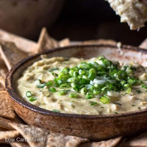 Low carb chicken enchilada dip with green onions and cilantro in a bowl with tortilla chips.