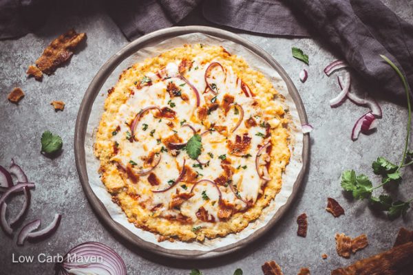 BBQ chicken pizza on a round pizza pan.