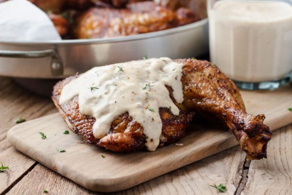 Alabama white BBQ sauce with smoked chicken quarters.