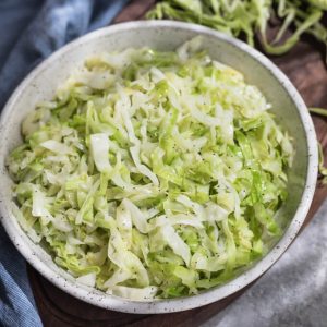 Buttery cabbage noodles with poppy seeds in a bowl.