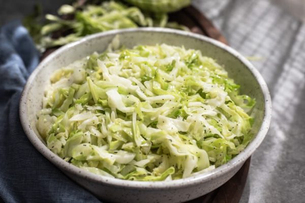 Buttery cabbage noodles with poppy seeds in a bowl.