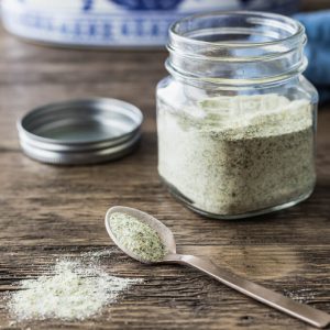 Homemade ranch seasoning mix in a jar and in a spoon.