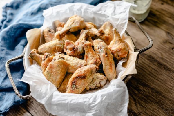 Tangy ranch chicken wings pieces in a basket.