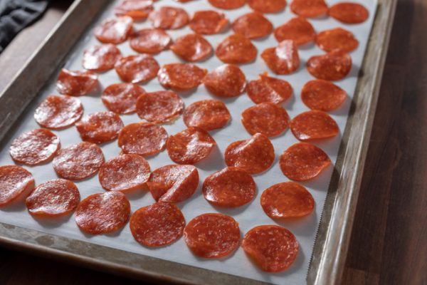 Pepperoni chips on a sheet pan before baking.