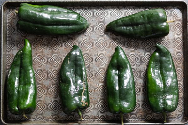 Poblano peppers on a sheet pan.