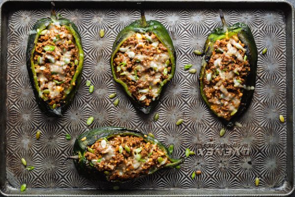 Stuffed poblano peppers on a sheet pan after baking.