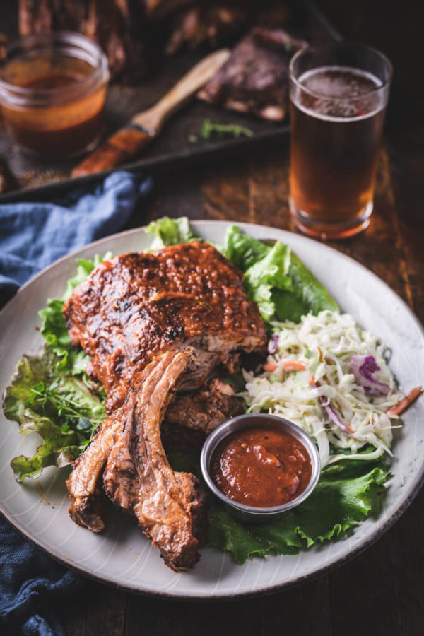 Baked baby back ribs bbq sauce and coleslaw on a plate