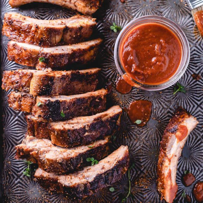 Keto oven baked ribs with BBQ sauce and drips