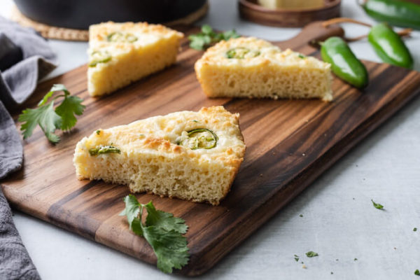 Slice of keto cornbread with jalapenos on a cutting board