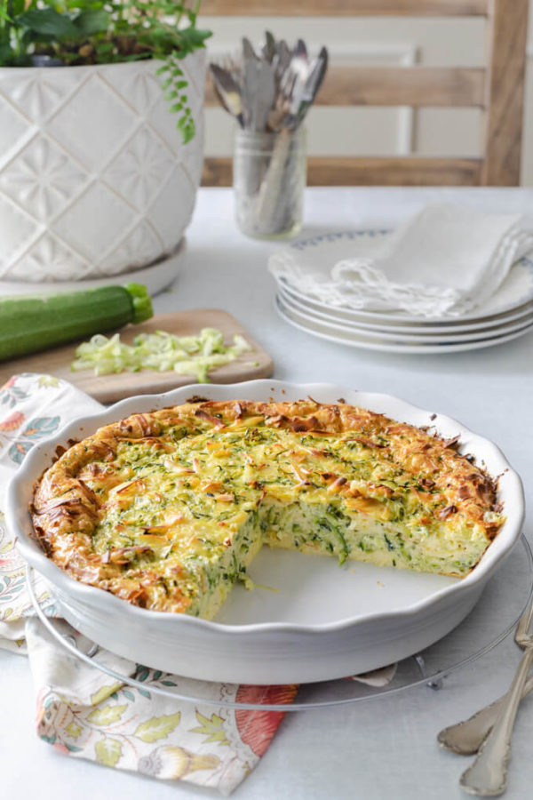 zucchini quiche in a quiche dish with grated zucchini