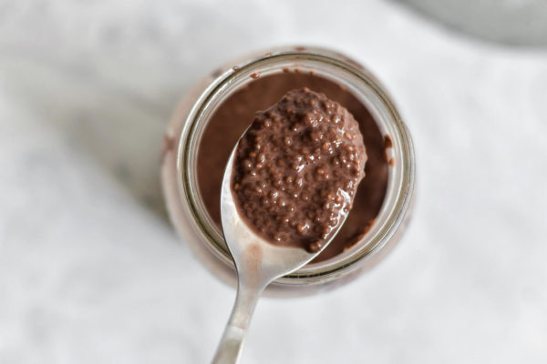 Chocolate chia seed pudding on a spoon.