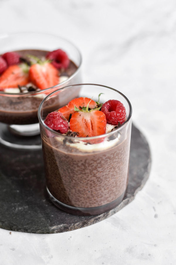 Keto chocolate chia pudding in a glass with strawberries and raspberries