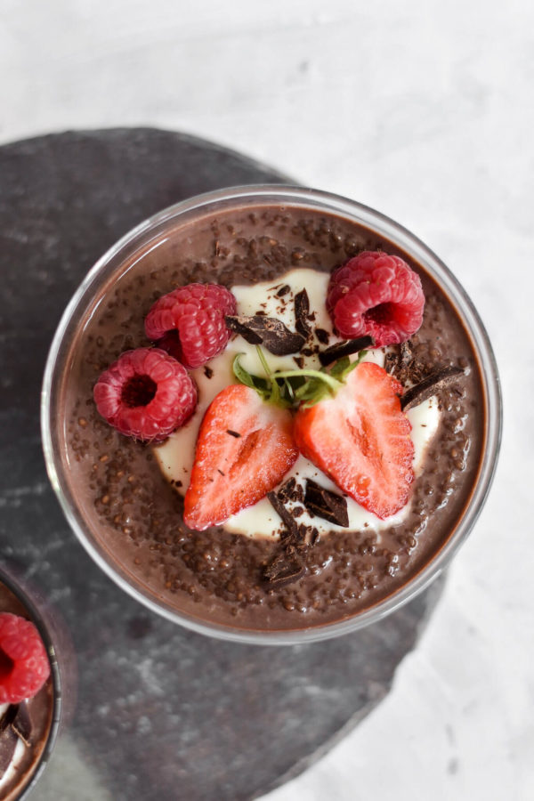 Keto chocolate chia pudding in a glass with strawberries and raspberries