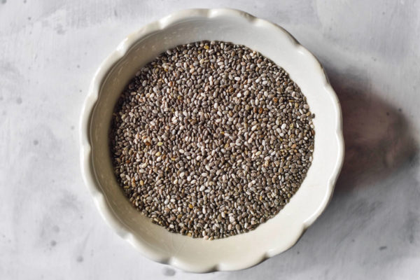 chia seeds in a scalloped white bowl.