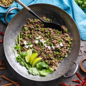 Keto green bean beef keema with yogurt, cilantro and limes in a wok