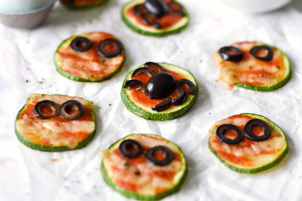 a side photograph of mini zucchini pizzas