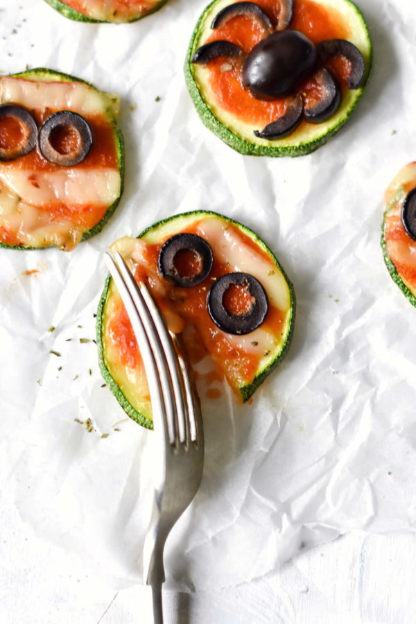 a fork diving into a zucchini pizza