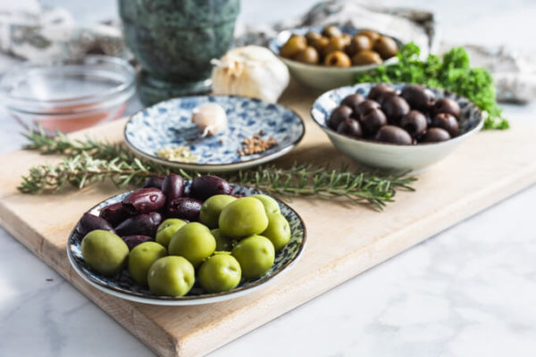 Marinated olives ingredients: assorted olives, spices, garlic, rosemary and parsley 