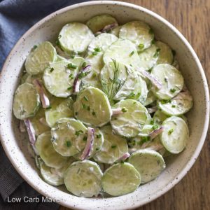 keto cucumber salad in a bowl with blue napkin beside